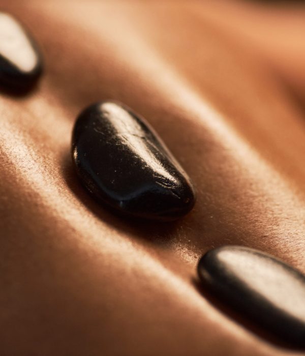 Warm basalt stones on back of young woman